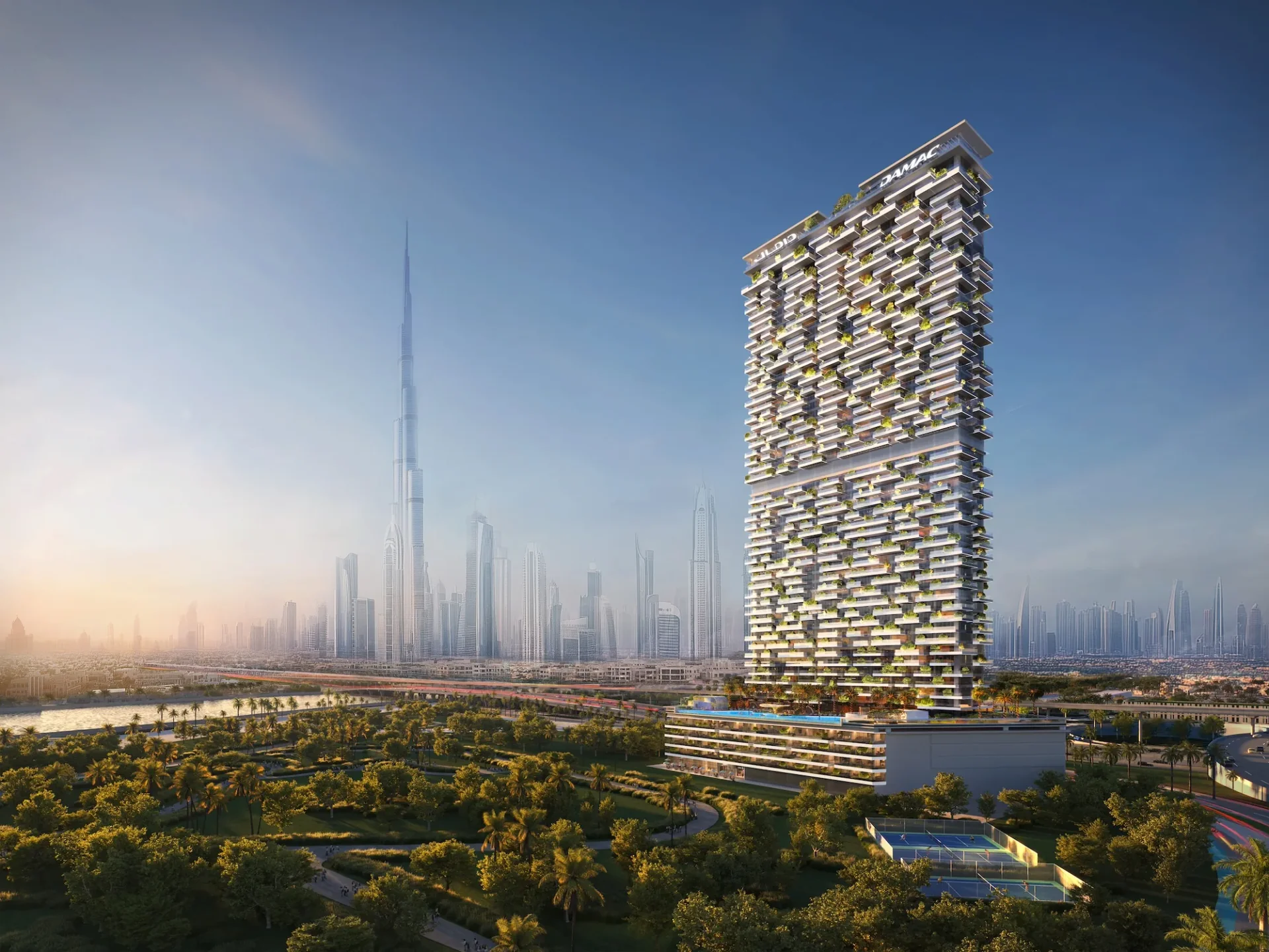 Safa Gate tower with Burj Khalifa skyline at sunrise