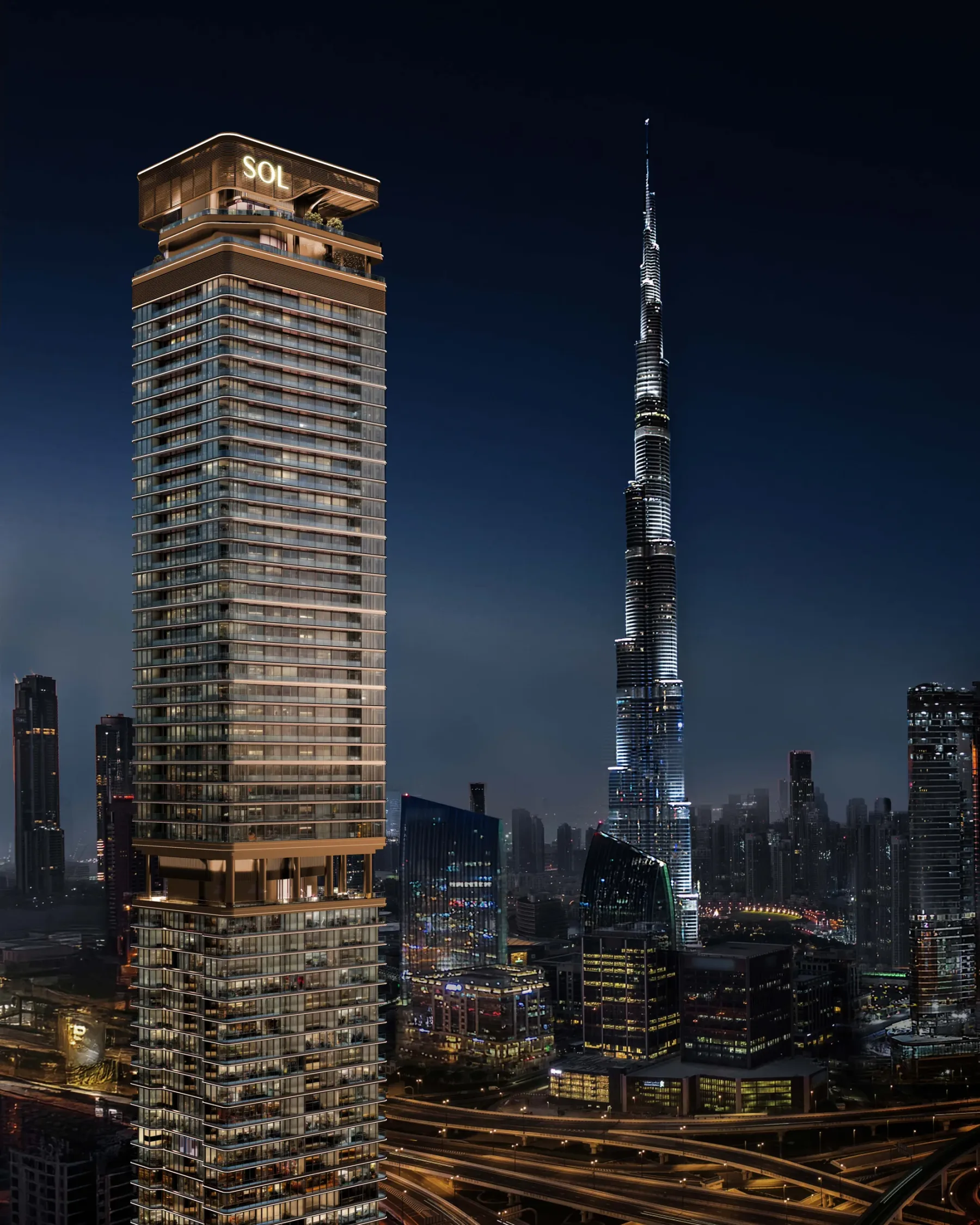Wieża SOL Luxe nocą z Burj Khalifa w tle (HERO)